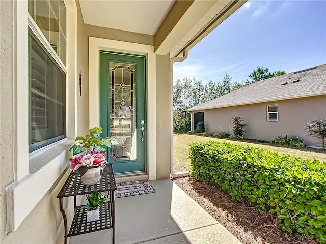 property entrance with stucco siding