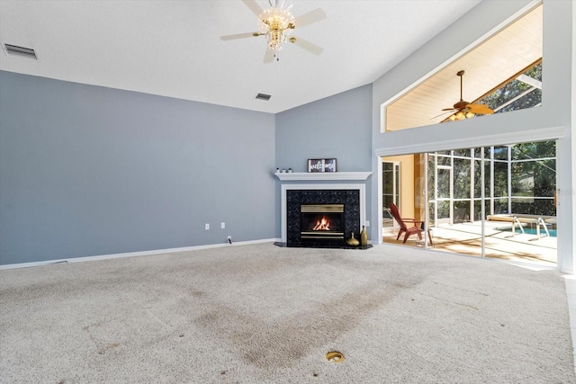 unfurnished living room featuring ceiling fan, carpet floors, a high end fireplace, and visible vents