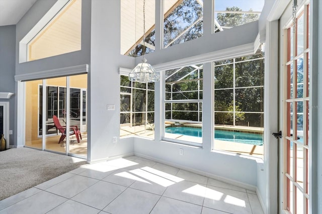 unfurnished sunroom featuring a notable chandelier and a healthy amount of sunlight