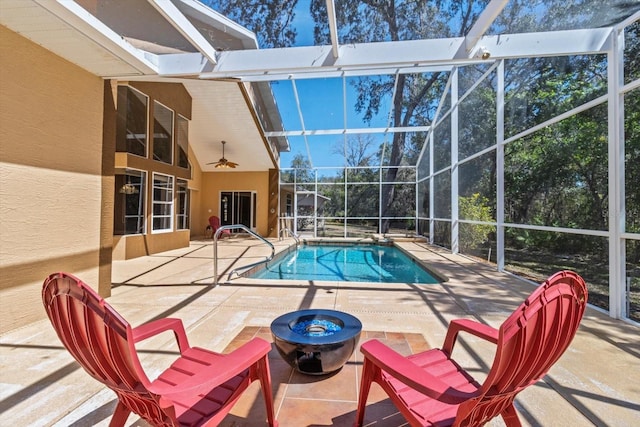 outdoor pool with a fire pit, a patio area, and a lanai