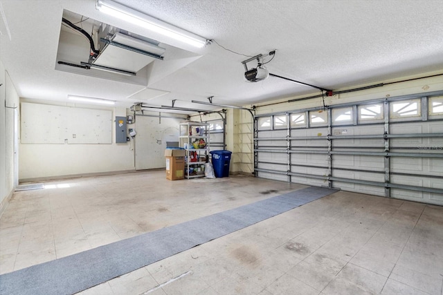 garage with a garage door opener, electric panel, and baseboards