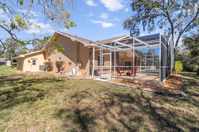 back of house with a patio, a lanai, a yard, an outdoor pool, and stucco siding