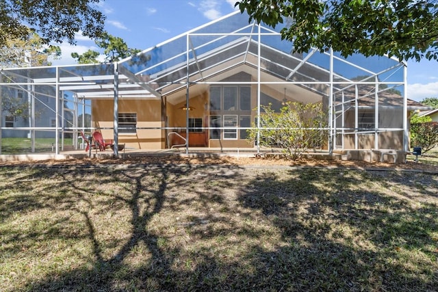 back of property with a patio area and glass enclosure