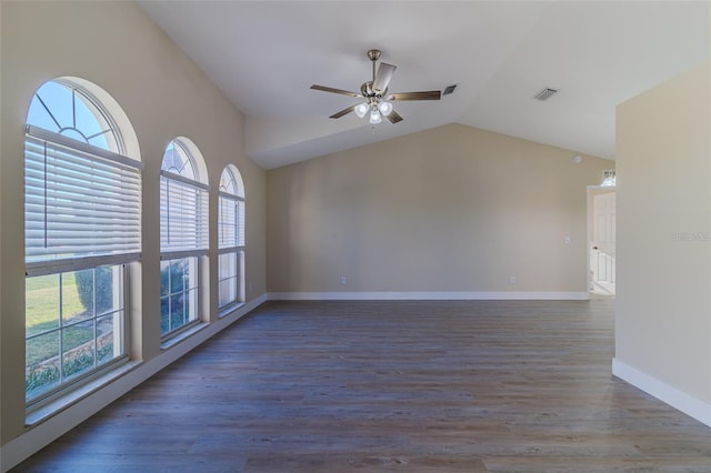 unfurnished room featuring wood finished floors, a ceiling fan, visible vents, and lofted ceiling