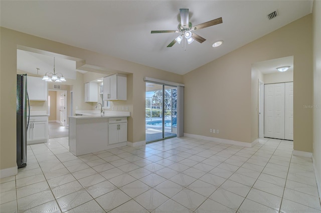 interior space with visible vents, baseboards, lofted ceiling, and a sink