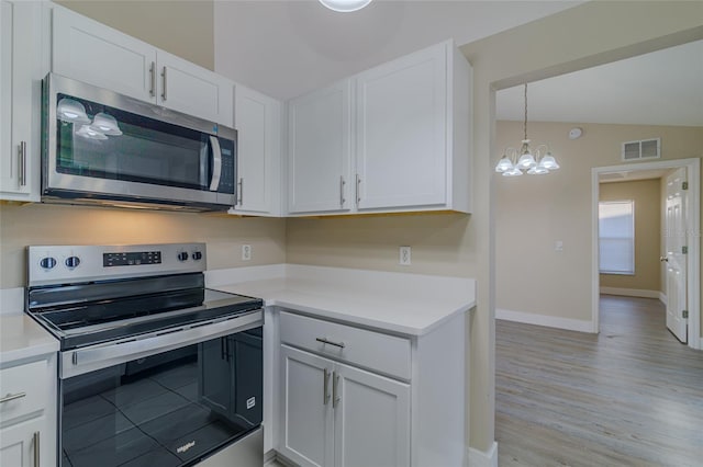 kitchen featuring stainless steel appliances, visible vents, white cabinets, and light countertops