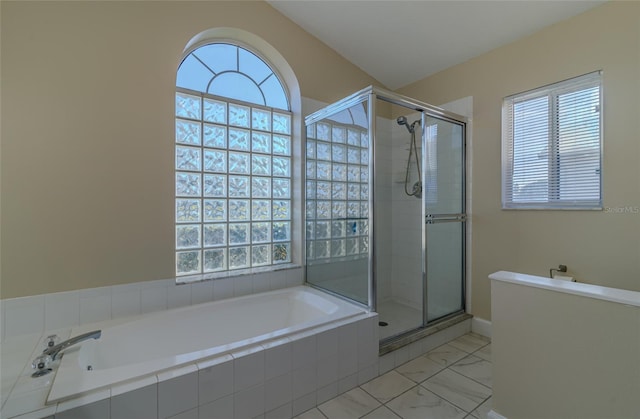 bathroom with a garden tub, a stall shower, and marble finish floor