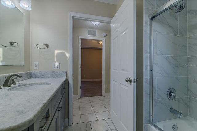 bathroom with vanity, baseboards, visible vents, a textured ceiling, and combined bath / shower with glass door