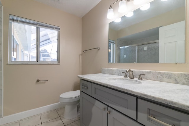 bathroom featuring baseboards, toilet, a stall shower, tile patterned floors, and vanity