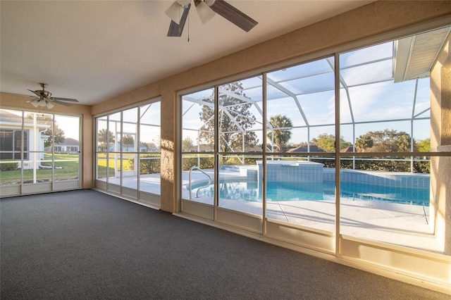 unfurnished sunroom featuring a ceiling fan