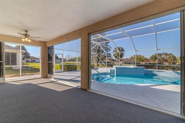 view of pool with a patio, a ceiling fan, a pool with connected hot tub, and a lanai