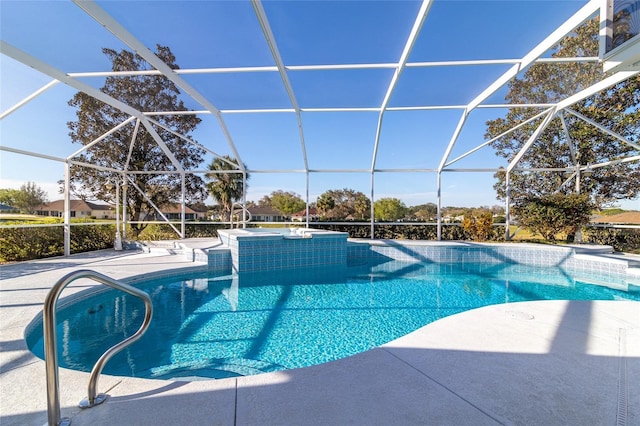 pool featuring glass enclosure and a patio