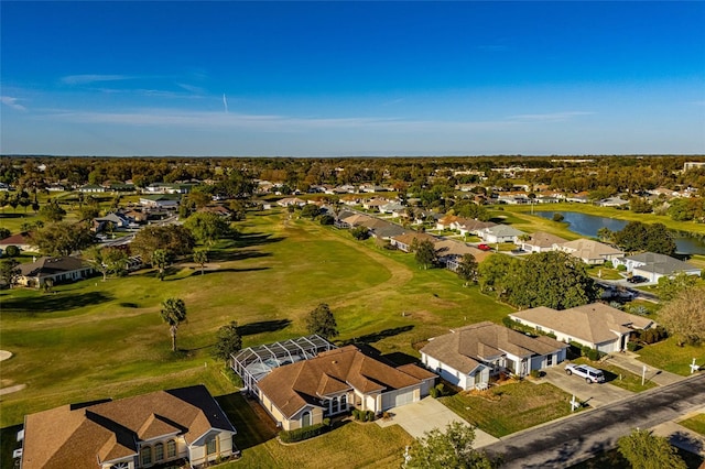 aerial view with a residential view, view of golf course, and a water view