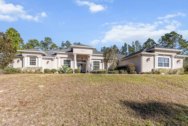 view of front of home with a front lawn and stucco siding