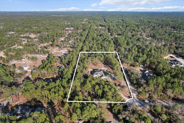 birds eye view of property with a wooded view