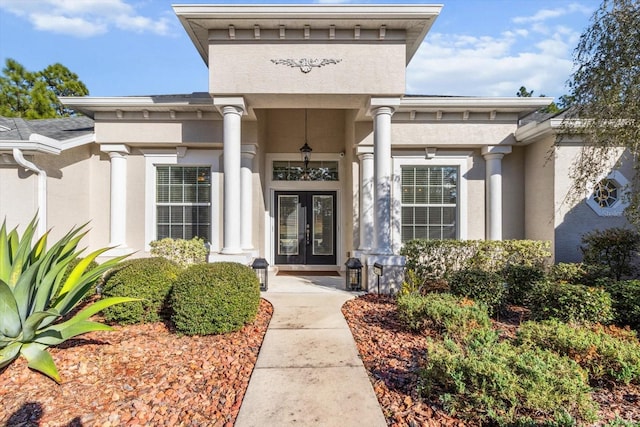 property entrance featuring french doors and stucco siding