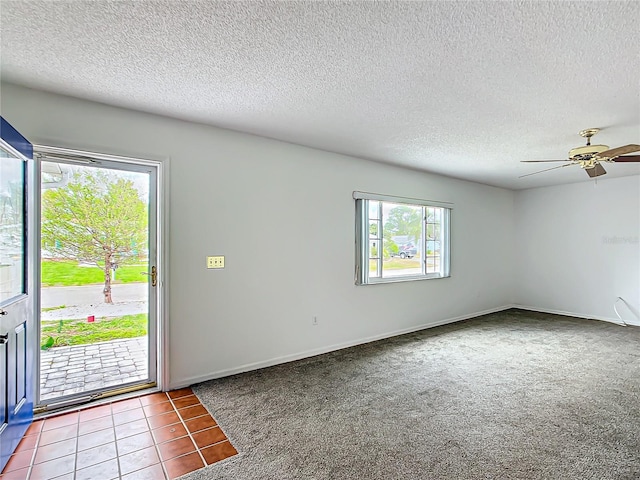 interior space featuring a textured ceiling, a ceiling fan, and baseboards