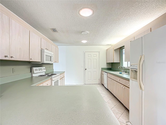 kitchen with white appliances, light tile patterned floors, visible vents, a textured ceiling, and a sink