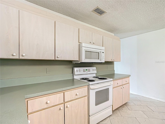 kitchen featuring white appliances, visible vents, a textured ceiling, and light brown cabinetry