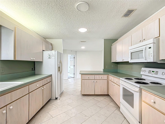 kitchen featuring white appliances, visible vents, a peninsula, marble finish floor, and light brown cabinetry