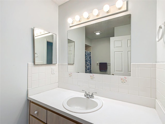 full bathroom featuring decorative backsplash and vanity