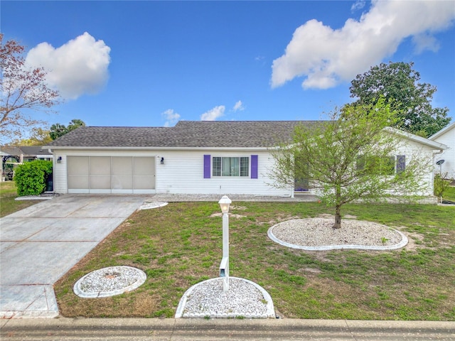 ranch-style home with a garage, a front yard, and driveway