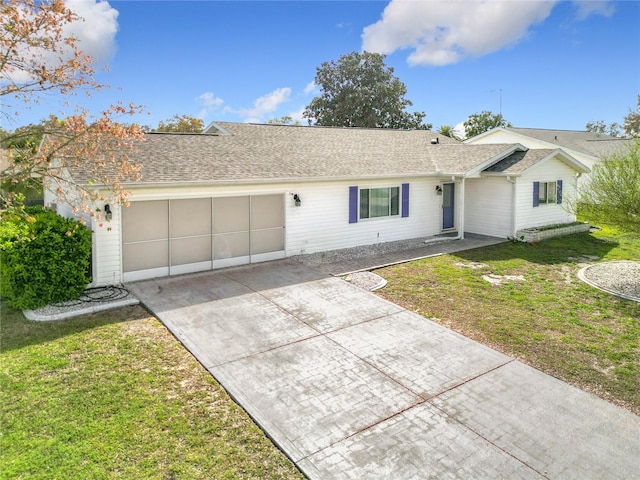 ranch-style house featuring a garage, driveway, a shingled roof, and a front lawn