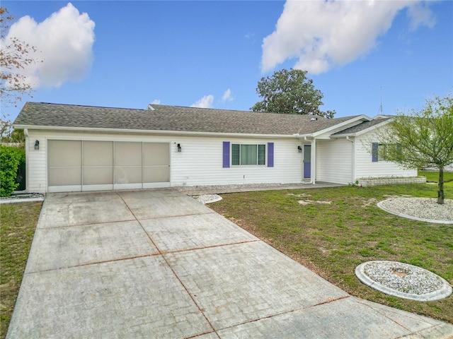 ranch-style house featuring a garage, driveway, and a front yard