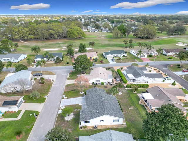 birds eye view of property with golf course view and a residential view