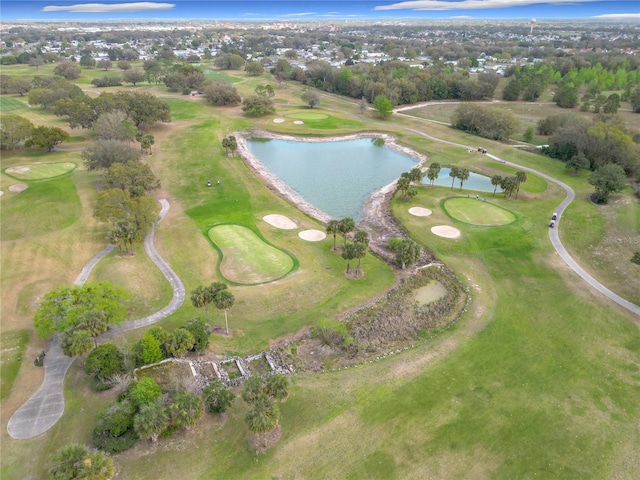 drone / aerial view with view of golf course and a water view