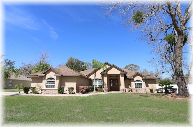 view of front of house featuring a front lawn and stucco siding