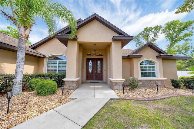 6307 SE 8th Ln, Ocala, FL 34472 - view of exterior entry with stucco siding and stone siding