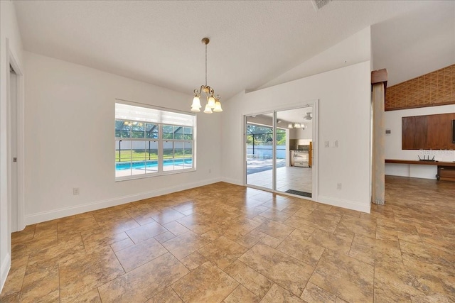 6307 SE 8th Ln, Ocala, FL 34472 - unfurnished dining area featuring stone tile floors, a chandelier, lofted ceiling, and baseboards