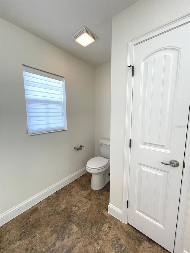 6307 SE 8th Ln, Ocala, FL 34472 - bathroom featuring toilet and baseboards