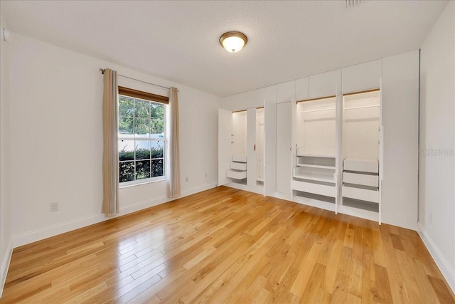 6307 SE 8th Ln, Ocala, FL 34472 - unfurnished bedroom featuring light wood-type flooring and baseboards