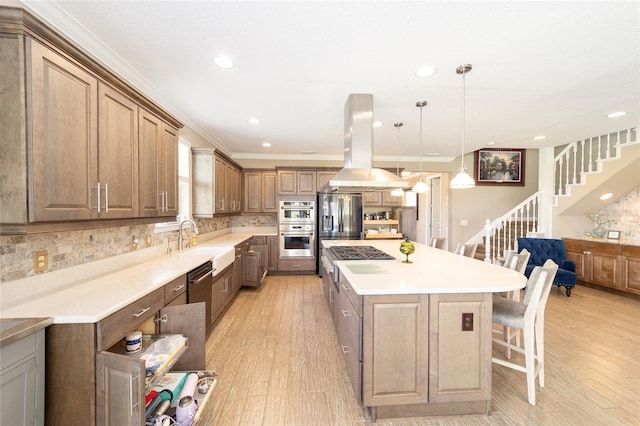 kitchen featuring tasteful backsplash, a kitchen breakfast bar, a center island, and island range hood