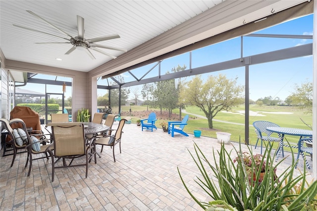 sunroom / solarium featuring ceiling fan