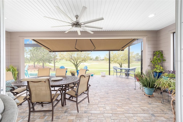 view of patio / terrace with a gazebo, outdoor dining area, and a ceiling fan