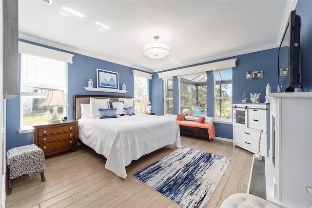 bedroom with a textured ceiling, wood finished floors, and ornamental molding