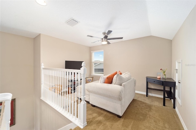 living area featuring a ceiling fan, visible vents, lofted ceiling, an upstairs landing, and light colored carpet