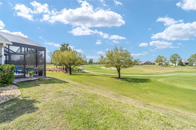 view of yard featuring a lanai and golf course view