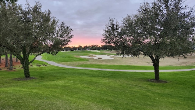 view of property's community featuring a lawn and golf course view