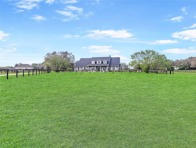 view of yard featuring a rural view and fence