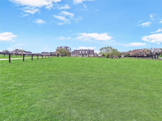 view of yard featuring a rural view and fence