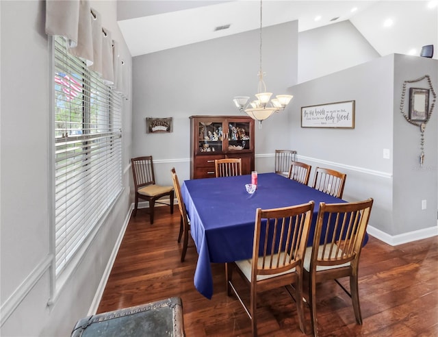 dining room with visible vents, vaulted ceiling, wood finished floors, a chandelier, and baseboards