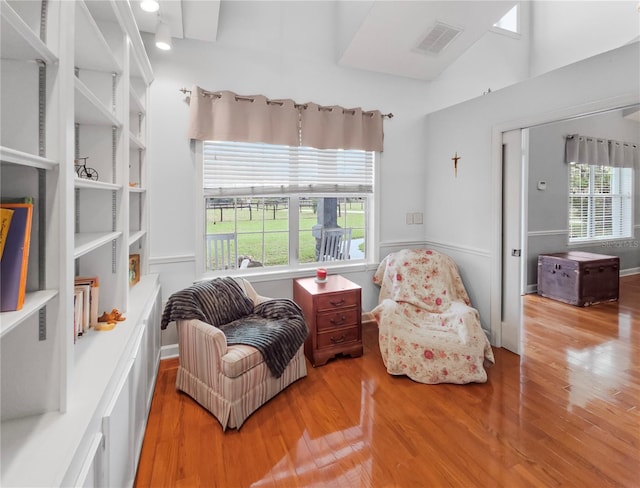 sitting room featuring visible vents and wood finished floors