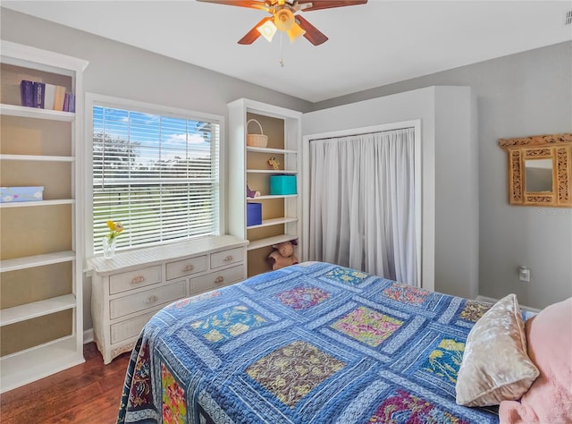 bedroom featuring visible vents, dark wood finished floors, and a ceiling fan