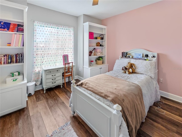 bedroom with ceiling fan, baseboards, and wood finished floors