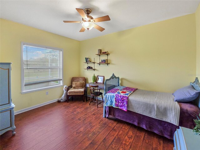 bedroom with ceiling fan, hardwood / wood-style flooring, and baseboards