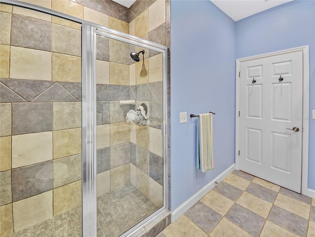 bathroom with a stall shower and baseboards